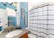 Nautical-themed bathroom featuring starfish decor, granite counter and blue striped shower curtain at 3329 Schoolhouse Rd, Harmony, FL 34773