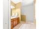 Bathroom featuring a wooden vanity with sink, a glass shower, and neutral tiles at 3329 Schoolhouse Rd, Harmony, FL 34773