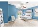 Stylish bedroom featuring a ceiling fan, balcony, and beach themed décor at 3329 Schoolhouse Rd, Harmony, FL 34773