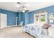 Nicely decorated bedroom with a ceiling fan and access to a balcony at 3329 Schoolhouse Rd, Harmony, FL 34773