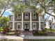 Stately two-story home featuring prominent white columns, a symmetrical facade, and lush landscaping at 3329 Schoolhouse Rd, Harmony, FL 34773