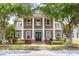 Stately two-story home featuring impressive white pillars, balconies, and mature trees at 3329 Schoolhouse Rd, Harmony, FL 34773