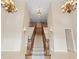 Soaring foyer with a grand staircase, elegant chandeliers, and gleaming tile floors at 3329 Schoolhouse Rd, Harmony, FL 34773