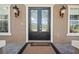 Elegant front entrance featuring a stylish door, decorative sidelights, and classic exterior lighting at 3329 Schoolhouse Rd, Harmony, FL 34773