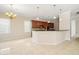 Open-concept kitchen with wooden cabinetry and barstool seating at 3329 Schoolhouse Rd, Harmony, FL 34773