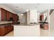 Modern kitchen featuring an island with sink, bar seating, and wood cabinets at 3329 Schoolhouse Rd, Harmony, FL 34773