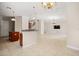 Open-concept living room featuring tile floors, a wet bar, and an elegant chandelier at 3329 Schoolhouse Rd, Harmony, FL 34773