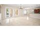 Bright living area with tile floors, chandelier, and sliding glass doors at 3329 Schoolhouse Rd, Harmony, FL 34773