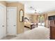 Spacious main bedroom featuring a decorative mirror, ceiling fan, and french doors to the patio at 3329 Schoolhouse Rd, Harmony, FL 34773