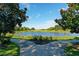 Scenic view of a pond surrounded by greenery and trees, great for tranquil living at 3329 Schoolhouse Rd, Harmony, FL 34773