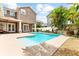 Exterior shot of the beautiful pool and patio with access to the home and a lush backyard at 3329 Schoolhouse Rd, Harmony, FL 34773