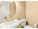 Cozy powder room with a pedestal sink and a circular mirror at 3329 Schoolhouse Rd, Harmony, FL 34773