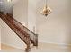 Inviting foyer features a staircase with wood banister and decorative chandelier at 3329 Schoolhouse Rd, Harmony, FL 34773