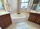 Soaking tub in bathroom with double sinks and a window for natural light at 3491 Allegra Cir, St Cloud, FL 34772