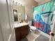 Bathroom with a single sink vanity, tile flooring, and shower with a playful 'Finding Nemo' themed curtain at 3491 Allegra Cir, St Cloud, FL 34772