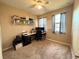 Cozy bedroom with a ceiling fan, carpet, and a modern desk setup, perfect for a home office at 3491 Allegra Cir, St Cloud, FL 34772
