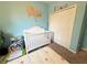 Bedroom featuring light blue walls, a white crib, and playful decor accents, creating a serene space at 3491 Allegra Cir, St Cloud, FL 34772