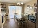 Bright dining room features a chandelier, large table, and sliding door to the patio at 3491 Allegra Cir, St Cloud, FL 34772