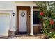 Inviting front entrance with a decorative wreath and flowering hibiscus bush at 3491 Allegra Cir, St Cloud, FL 34772