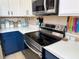 Updated kitchen features modern stainless steel appliances, white countertops, and two-toned cabinets at 3491 Allegra Cir, St Cloud, FL 34772