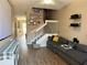 Comfortable living room featuring a staircase, hardwood floors, and media center at 3491 Allegra Cir, St Cloud, FL 34772
