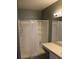 Clean bathroom featuring a walk-in shower, vanity with a sink, and neutral color palette at 350 Chelmsford Ct, Kissimmee, FL 34758