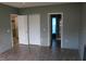 Spacious bedroom with wood-look floors, closet, and ensuite bathroom at 350 Chelmsford Ct, Kissimmee, FL 34758