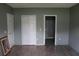 Bedroom featuring wood look flooring and neutral wall color throughout at 350 Chelmsford Ct, Kissimmee, FL 34758
