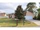 Quaint single-Gathering home showcasing a lush lawn, a mature tree, and a convenient two-car garage at 350 Chelmsford Ct, Kissimmee, FL 34758