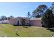 Charming single-story home featuring manicured lawn and mature trees at 350 Chelmsford Ct, Kissimmee, FL 34758