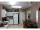 Bright kitchen with ample storage, white cabinets, modern appliances, and an adjacent dining area at 350 Chelmsford Ct, Kissimmee, FL 34758