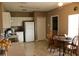 Traditional kitchen with white appliances, neutral cabinetry, and a tile floor that complements the home's interior at 350 Chelmsford Ct, Kissimmee, FL 34758
