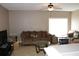 Inviting living room featuring tile flooring, a comfortable sofa, and a television for entertainment at 350 Chelmsford Ct, Kissimmee, FL 34758