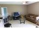 Inviting living room featuring tile flooring, a comfortable sofa, and a television for entertainment at 350 Chelmsford Ct, Kissimmee, FL 34758