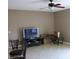 Comfortable living room with neutral tones, tiled floors, ceiling fan, and minimalist decor at 350 Chelmsford Ct, Kissimmee, FL 34758