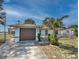 Inviting single-story home with a well-manicured lawn, driveway, and a blue sky backdrop at 426 Paradise Island Dr, Haines City, FL 33844