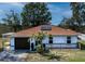 Lovely single-story home with a well-manicured lawn, driveway, and a blue sky backdrop at 426 Paradise Island Dr, Haines City, FL 33844