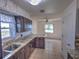 Modern kitchen featuring granite countertops, stainless steel appliances, dark wood cabinets, and tile flooring at 426 Paradise Island Dr, Haines City, FL 33844