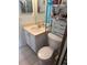 Well-lit bathroom featuring a modern vanity, toilet, and convenient storage shelves for toiletries at 466 Club Dr, Winter Springs, FL 32708