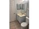 Cozy bathroom features a vanity with blue cabinets, a toilet, and tiled floor at 466 Club Dr, Winter Springs, FL 32708