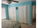 Bedroom showcasing two closets, light-colored floors, a ceiling fan, and soothing blue walls at 466 Club Dr, Winter Springs, FL 32708
