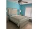 Inviting bedroom with blue walls, a comfortable bed, and natural light from a large window at 466 Club Dr, Winter Springs, FL 32708