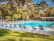 Community pool with lounge chairs and umbrellas at 466 Club Dr, Winter Springs, FL 32708
