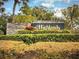Entrance to The Highlands neighborhood with lush landscaping at 466 Club Dr, Winter Springs, FL 32708