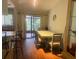 Sunlit dining area with wood floors and access to the patio at 466 Club Dr, Winter Springs, FL 32708