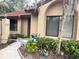 Charming home exterior with a red tile roof, lush landscaping, and beautiful architectural details at 466 Club Dr, Winter Springs, FL 32708