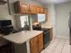 Well-lit kitchen features wooden cabinets, stainless steel appliances, and a breakfast bar at 466 Club Dr, Winter Springs, FL 32708