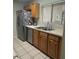 Kitchen features stainless steel appliances, a window, and wood cabinets at 466 Club Dr, Winter Springs, FL 32708