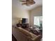 Cozy living room with a high ceiling, comfortable sofa, television, and a large window at 466 Club Dr, Winter Springs, FL 32708