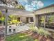 Outdoor patio area with seating, a pergola, and beautiful landscaping at 466 Club Dr, Winter Springs, FL 32708